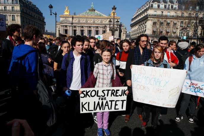 CAPTION ADDITION ADDS THE DATE Swedish teenager Greta Thunberg, center, leads a march of thousands of French students through Paris, France, Friday, Feb. 22, 2019, to draw more attention to fighting climate change. Sign reads : "school strike for the climate". (AP Photo/Francois Mori)