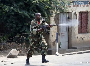 A soldier fires AK-47 rifle during a protest against President Pierre Nkurunziza and his bid for a third term in Bujumbura